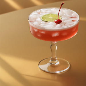 An image of the Death Bed cocktail submitted by Toby that contains Gold Rum, Agricole Rhum, Cherry Brandy, Lime, Pineapple Juice, Lime and Cocktail Cherry