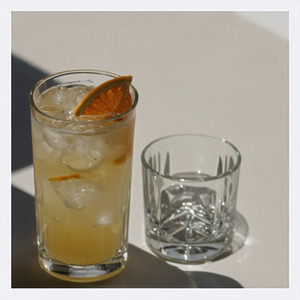 An image of the Ginger Baker Fizz cocktail submitted by Toby that contains London Dry Gin, Lemon, Crème de Cacao Blanc, Ginger Liqueur, Cream, Egg, Ginger Beer and Orange