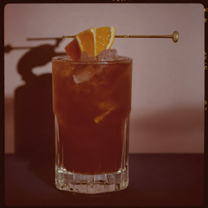 An image of the Heavy Artillery cocktail submitted by n0tquitethere that contains Rye Whiskey, Smith & Cross, Green Chartreuse, Sweet Vermouth, Cinnamon Syrup, Demerara Syrup, Whiskey Barrel Aged Bitters and Orange