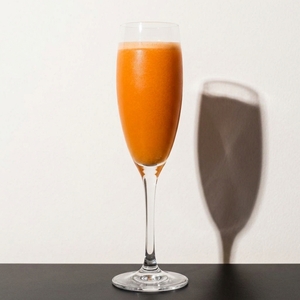 An image of the Bellini cocktail submitted by Toby that contains Peach Purée, Prosecco and Peach Schnapps