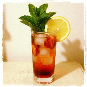 An image of the Belmont Breeze cocktail submitted by Toby that contains Rye Whiskey, Cream Sherry, Simple Syrup, Lemon, Orange, Lemonade, Soda Water, Strawberries, Mint and Lemon