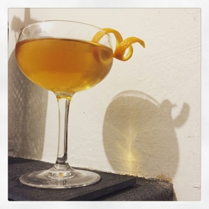 An image of the Bronco Buster cocktail submitted by Toby that contains Applejack, Rye Whiskey, Curaçao Triple Sec, Lemon, Simple Syrup and Orange