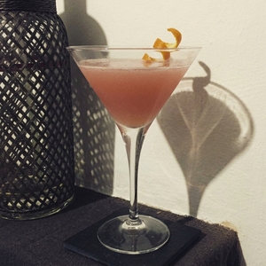 An image of the Cosmopolitan cocktail submitted by Toby that contains Lemon Vodka, Curaçao Triple Sec, Lime, Cranberry Juice, Simple Syrup and Orange
