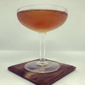 An image of the East India Cocktail cocktail submitted by Toby that contains Brandy, Raspberry Syrup, Angostura Bitters, Curaçao Triple Sec, Maraschino Liqueur and Cocktail Cherry