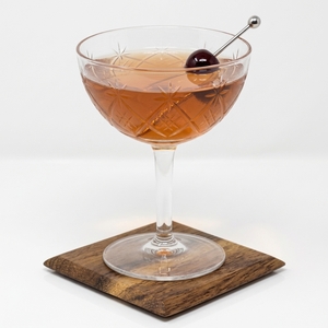 An image of the East India Cocktail cocktail submitted by Toby that contains Brandy, Raspberry Syrup, Angostura Bitters, Curaçao Triple Sec, Maraschino Liqueur and Cocktail Cherry