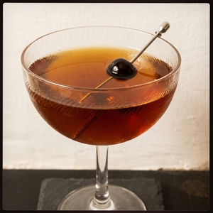 An image of the Made Man cocktail submitted by Toby that contains Rye Whiskey, Cherry Heering, Yellow Chartreuse, Fernet Branca and Cocktail Cherry