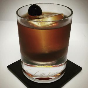 An Instagram of the Old Ironside cocktail submitted by n0tquitethere that contains Spiced Rum, Cherry Brandy, Cynar and Cocktail Cherry