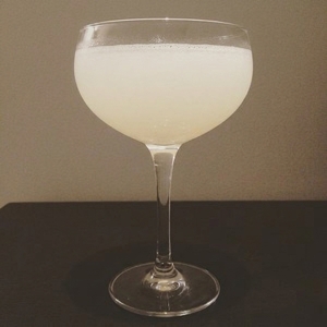 An image of the Pink Chocolate Martini cocktail submitted by Toby that contains Vanilla Vodka, Crème de Cacao Blanc, Amaretto, Grenadine and Canned Whipped Cream