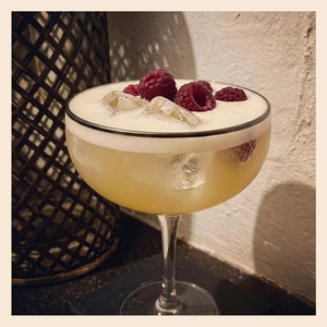 An image of the Zelda cocktail submitted by Toby that contains London Dry Gin, Lemon, Raspberry Lambic, Cinnamon, Star Anise, Fresh Ginger, Egg, Caster Sugar and Raspberries
